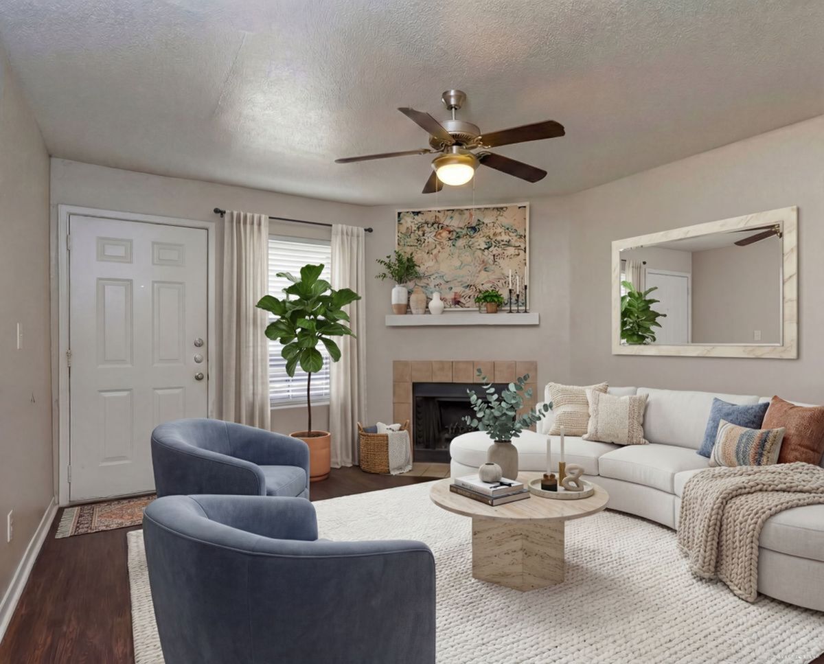 Inviting living room with elegant decor, featuring a cozy fireplace, plush seating, and stylish accents for a warm ambiance.