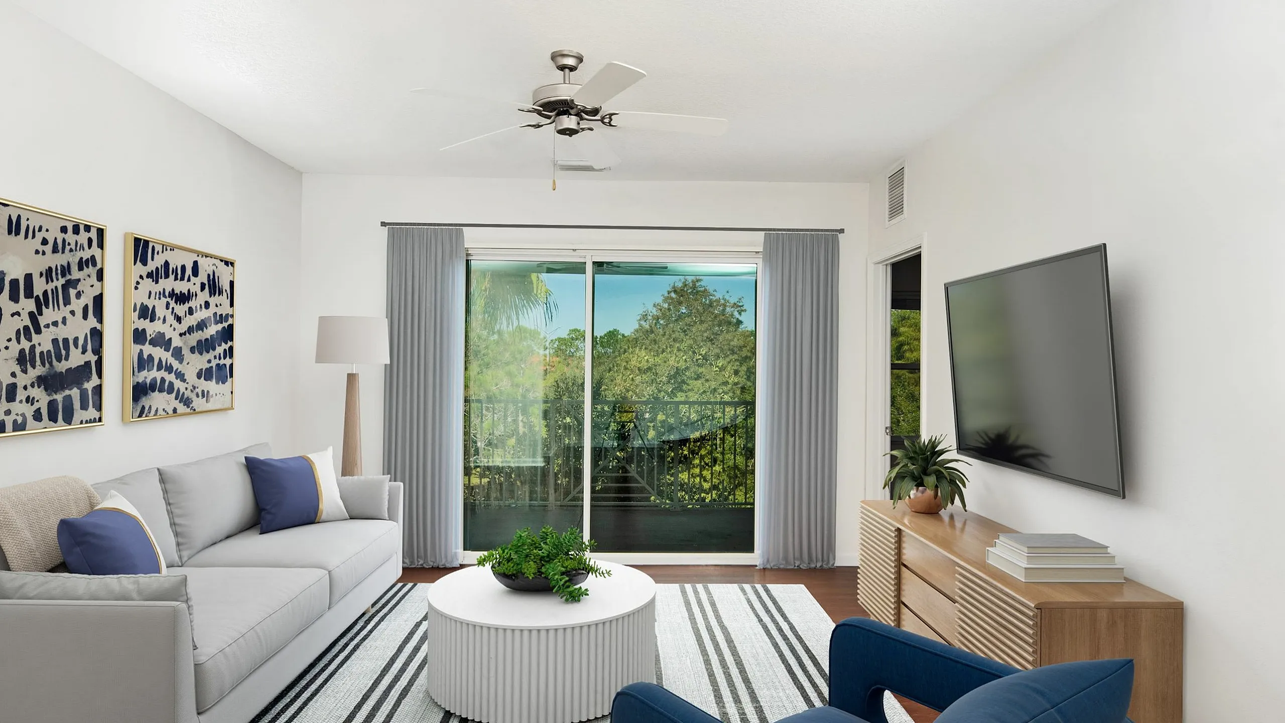 Bright living room with large windows, modern decor, and a cozy seating area.