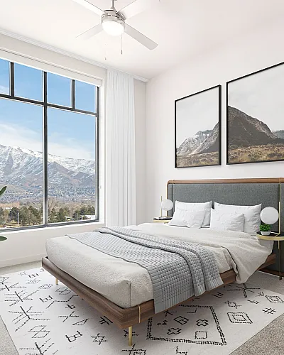 Elegant bedroom with modern decor and large window offering stunning mountain views, complemented by cozy bedding and stylish furniture.