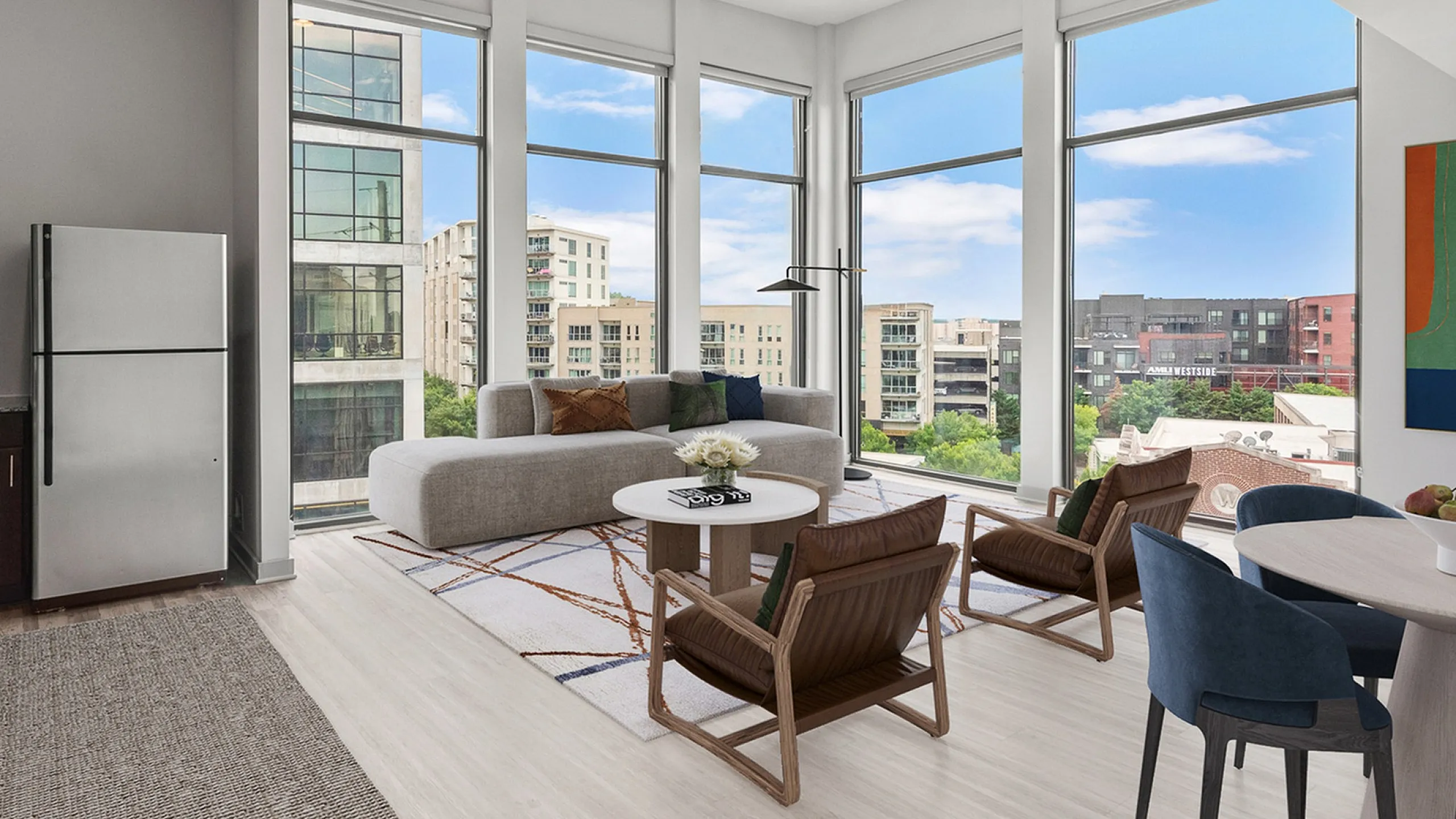 Modern open-concept living space at Cottonwood Westside Apartments with floor-to-ceiling windows, stylish decor, and a stunning urban view in West Midtown Atlanta.