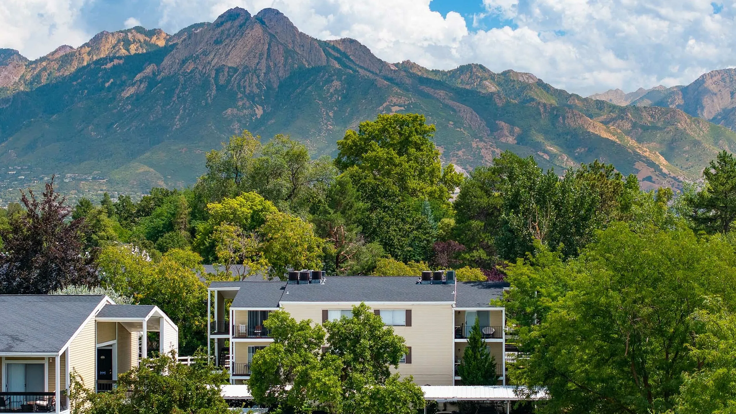 Charming apartment complex, Fox Point Apartments, surrounded by lush greenery and scenic mountain views, offering a tranquil and picturesque living environment in Salt Lake City.