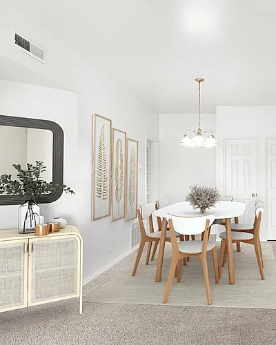 Bright and modern apartment at Fox Point in Old Farm Apartments dining area with elegant table and chairs, opening to a cozy kitchen with bar seating.