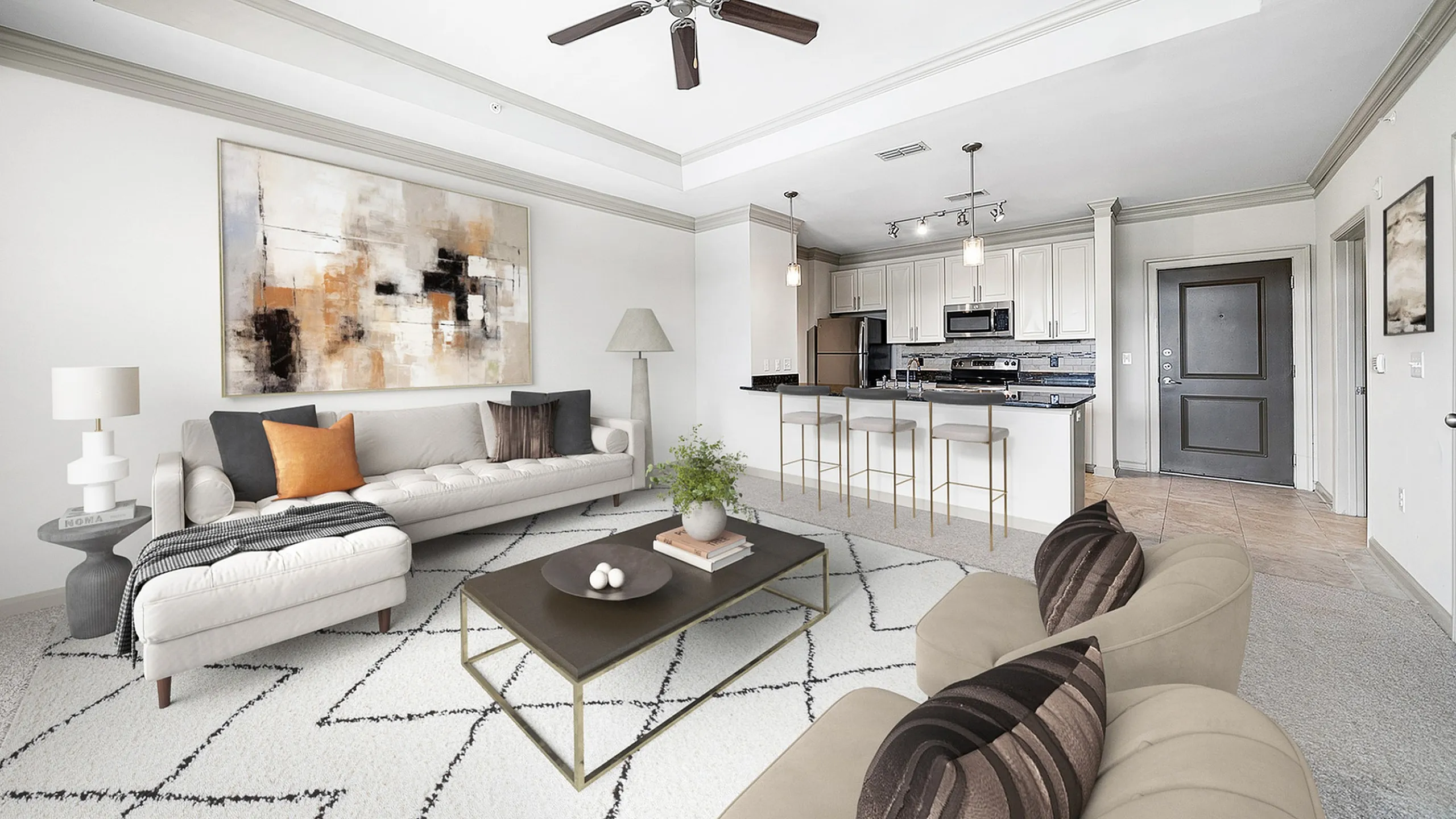 Sophisticated open-plan living room at Heights at Meridian Apartments with elegant decor, modern kitchen, and cozy seating area under a stylish ceiling fan.