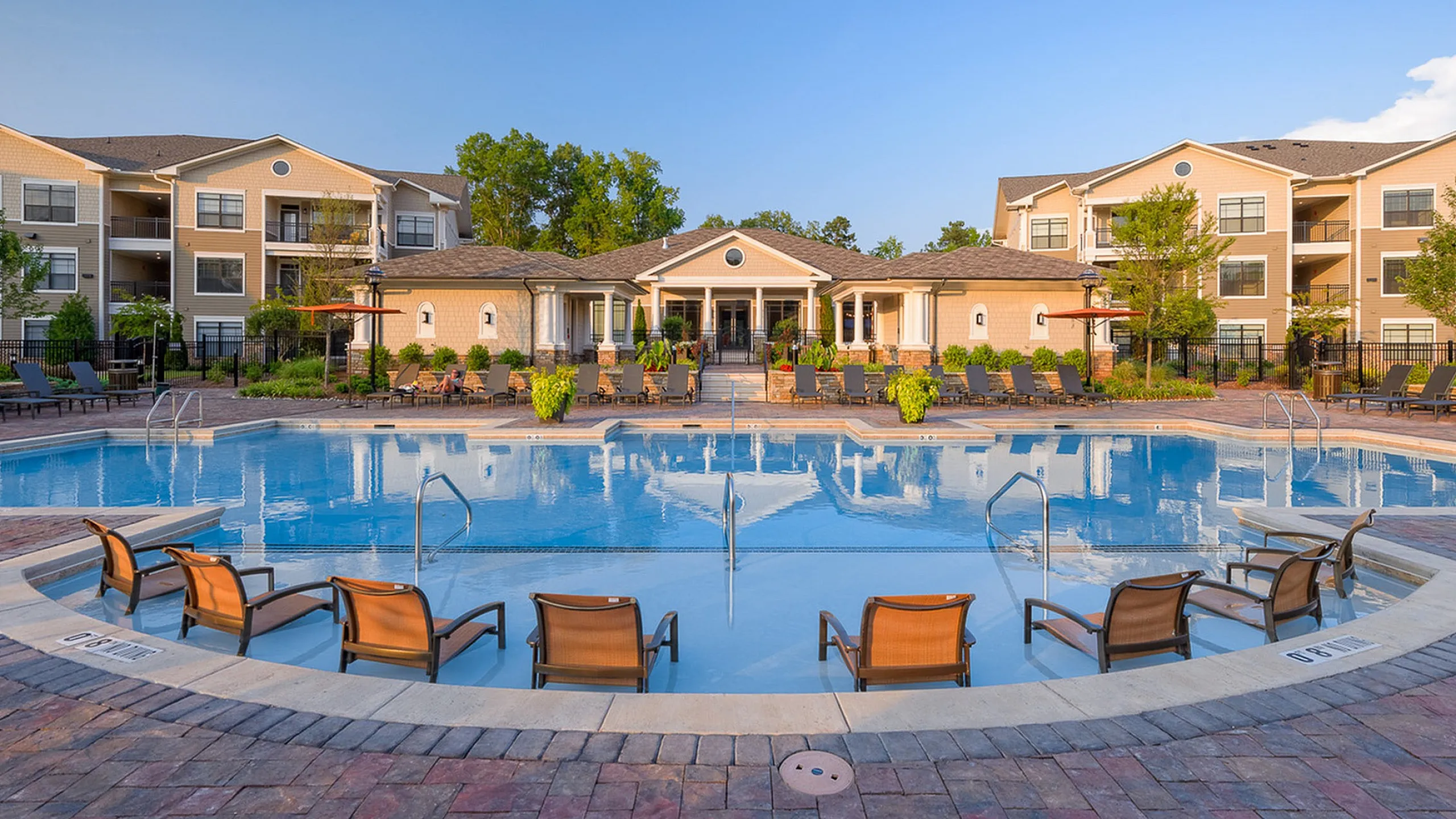 Luxurious apartment complex, Heights at Meridian, featuring a stunning pool area with comfortable lounge chairs and beautifully landscaped surroundings.
