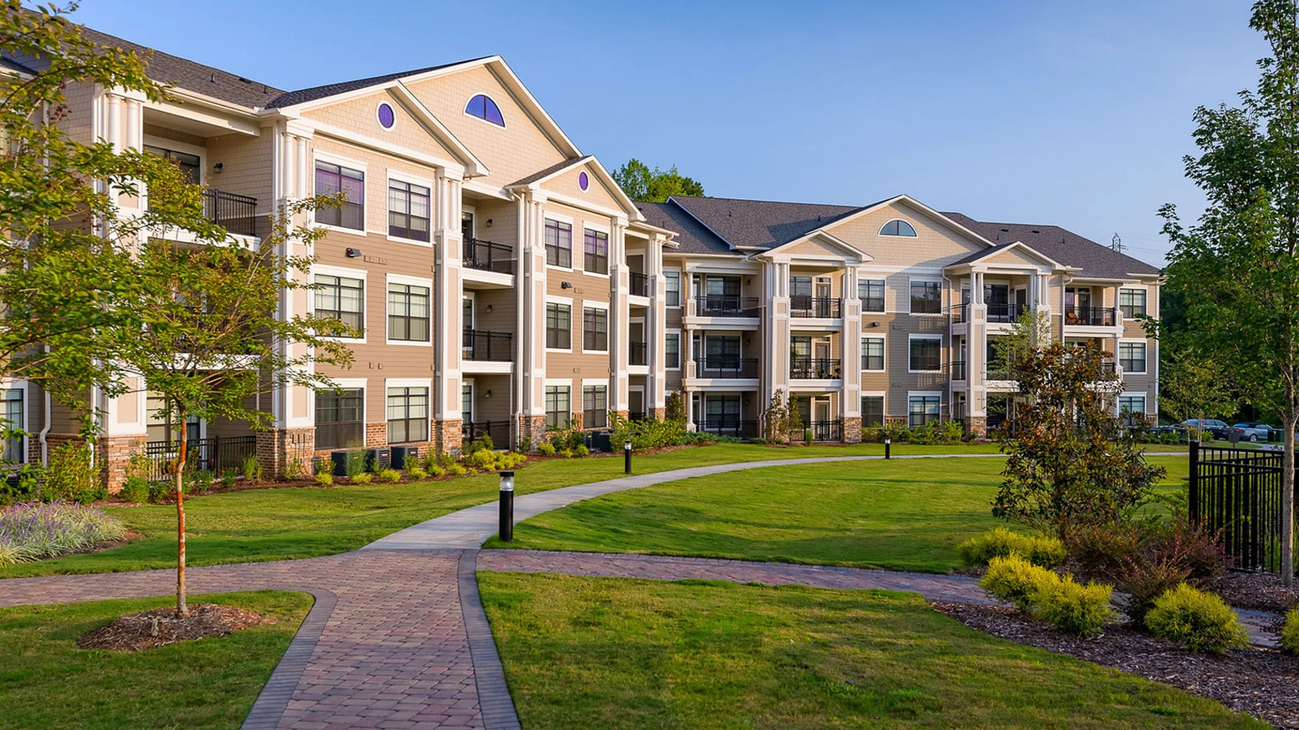 Elegant apartment complex, Heights at Meridian, with modern architecture, surrounded by lush greenery and a well-maintained walking path.