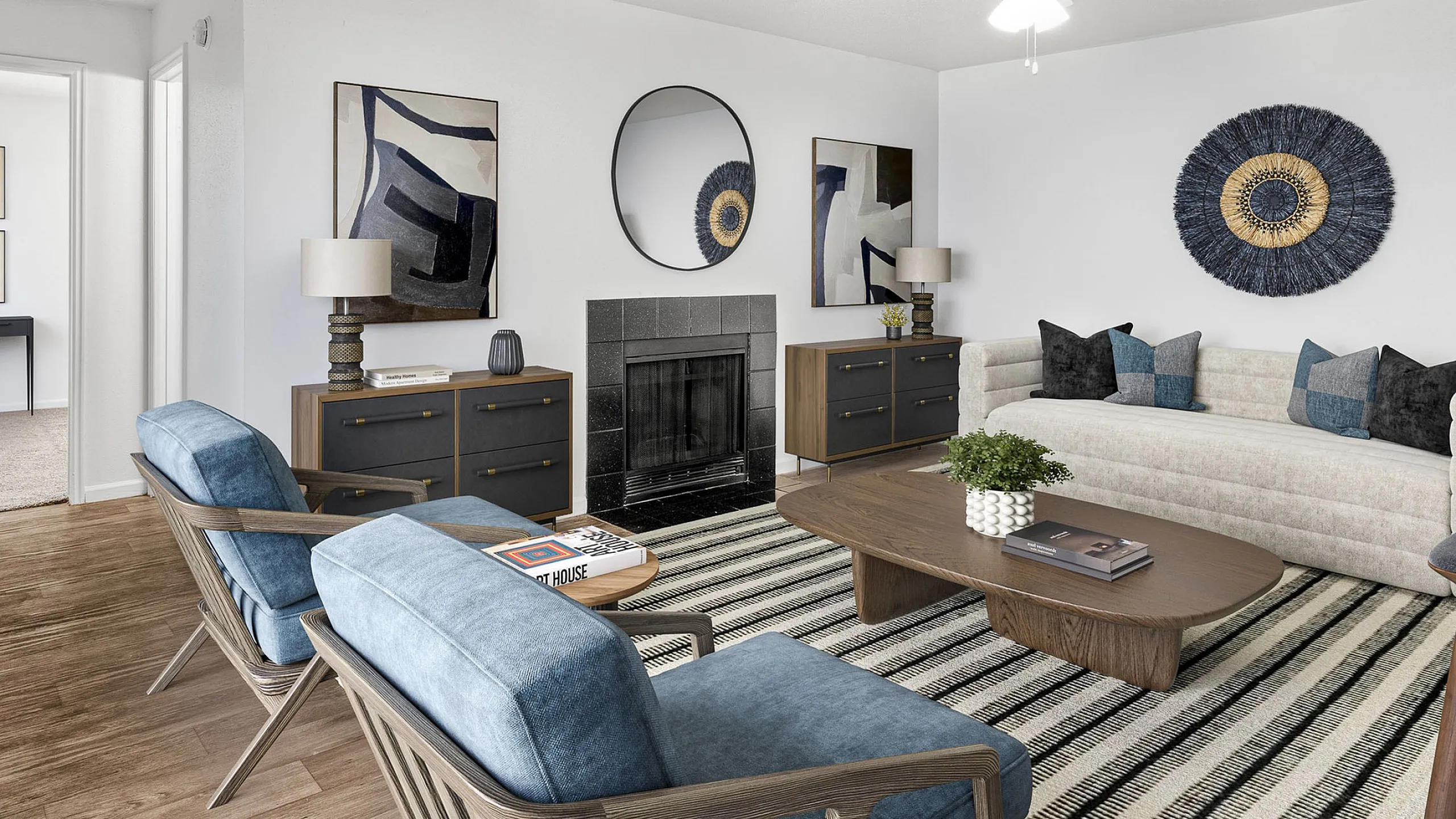 Elegant living room at Cottonwood Apartments with modern decor, featuring a cozy fireplace, stylish furniture, and eye-catching wall art.