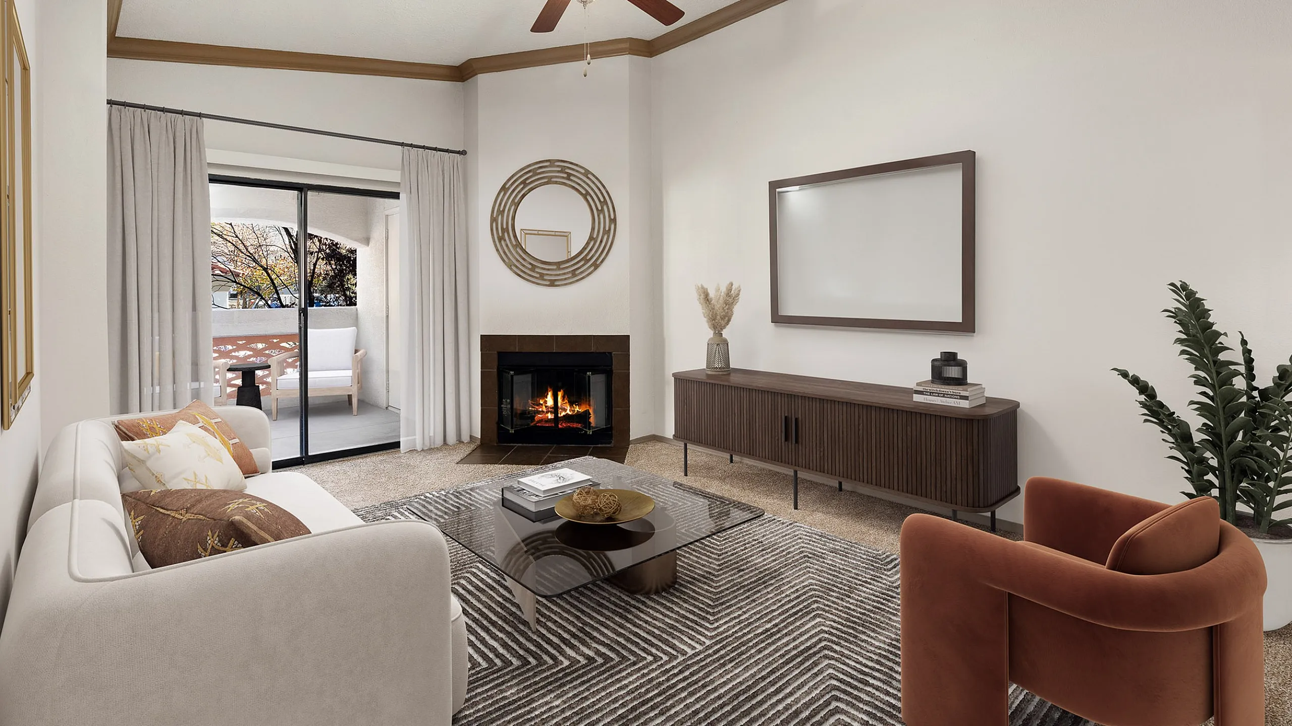 Inviting living room with a cozy fireplace, elegant decor, and sliding glass doors leading to a sunlit balcony.