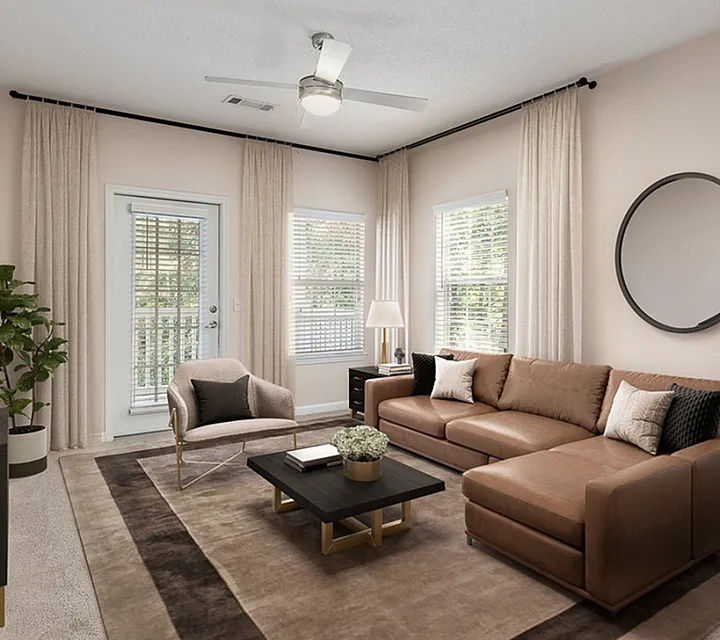 Elegant living room featuring a cozy brown sectional sofa, modern armchair, and stylish decor with natural light streaming through large windows.