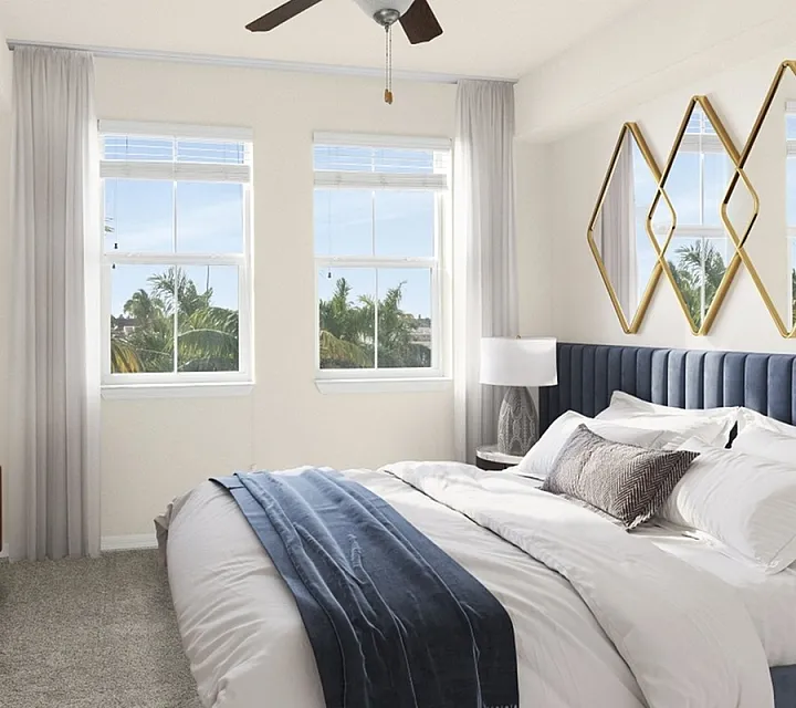 Bright and airy bedroom with elegant decor, showcasing a luxurious bed, large windows with lush green views, and sophisticated modern accents.