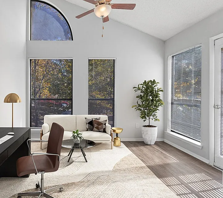 Bright and modern home office with large windows, stylish furnishings, and a relaxing ambiance.
