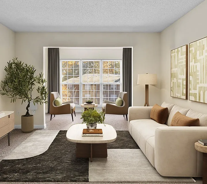 Elegant living room with modern decor, featuring a plush sofa, chic armchairs, and a stylish coffee table, all illuminated by natural light through large windows.