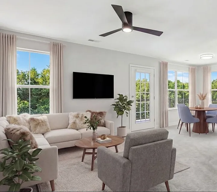 Bright and inviting living room featuring modern decor, plush seating, and a scenic view from large windows, perfect for relaxation in style.