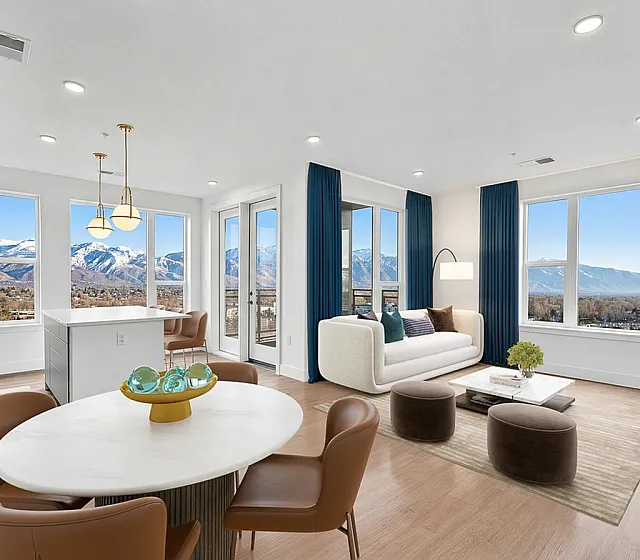 Luxurious open-plan apartment with stunning mountain views, featuring modern furnishings, an elegant dining area, and floor-to-ceiling windows.