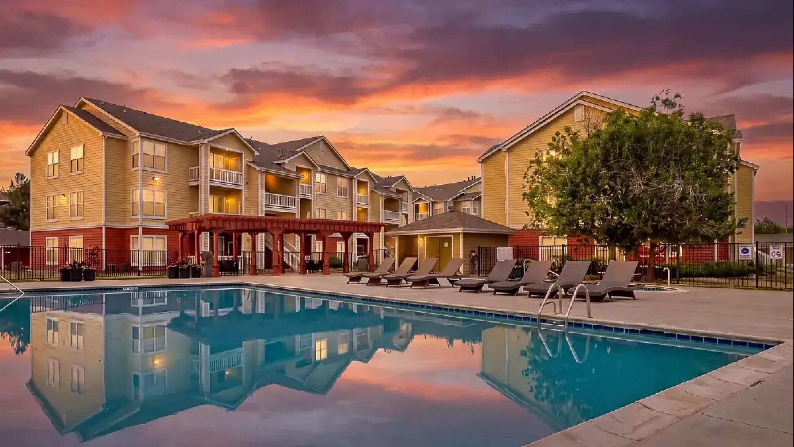 The Orchards at Cherry Creek Park Apartments pool and exterior at sunset.