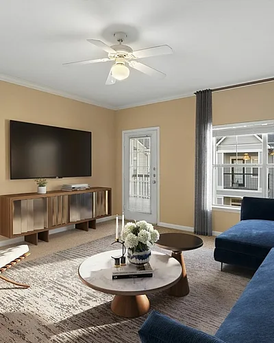 Chic and modern living room with stylish decor, featuring a plush blue sectional sofa, sleek TV unit, and abundant natural light.