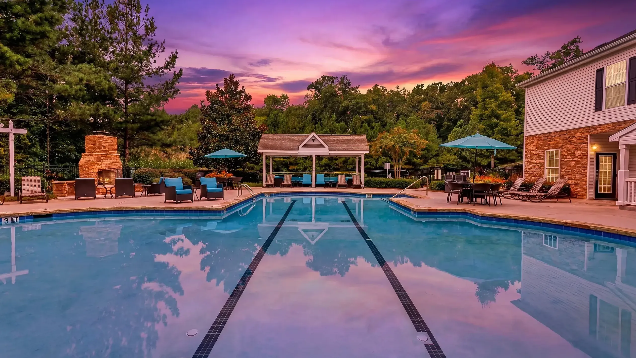 Charming apartment complex with classic architecture, lush landscaping, and spacious balconies perfect for relaxing and enjoying the view at Summer Park Apartments in Buford GA