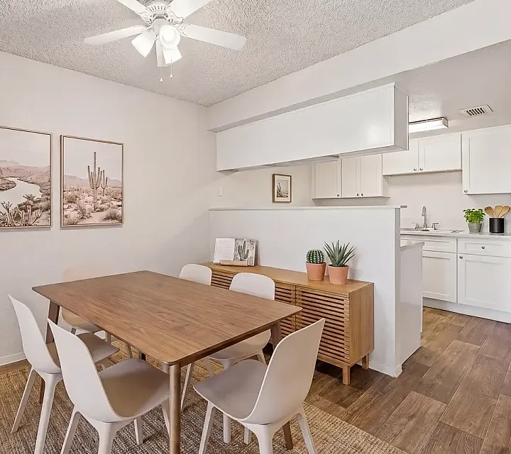 Inviting open-plan living area with cozy sofa, stylish armchair, and sleek modern kitchen, perfect for relaxation and entertaining.