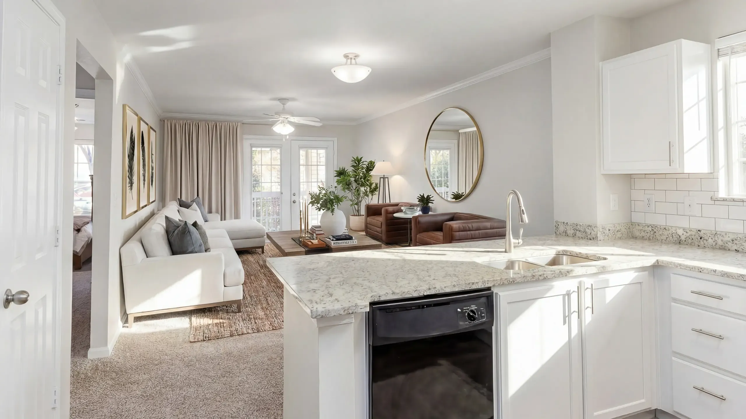 Bright and modern living space featuring an open-concept kitchen with granite countertops, cozy seating area, and sleek decor.