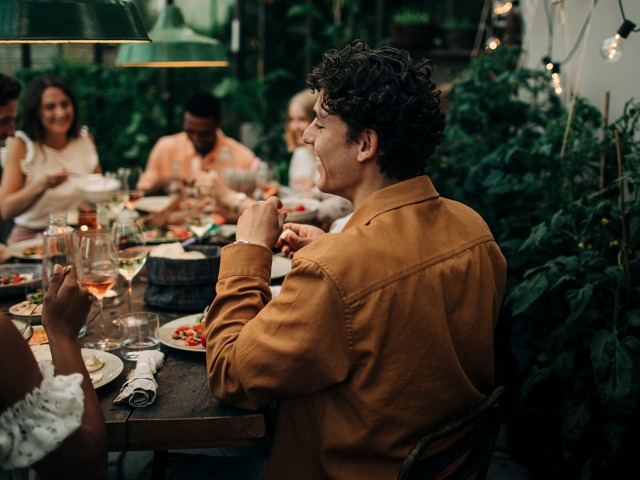 friends at restauarant smiling together modera garden oaks apartment homes for rent