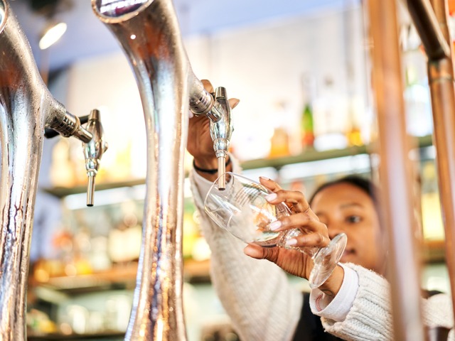 drink being poured at bar modera garden oaks apartment homes for rent