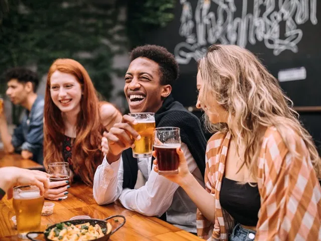 friends having beer outside modera raleigh hills apartment homes for rent in oregon