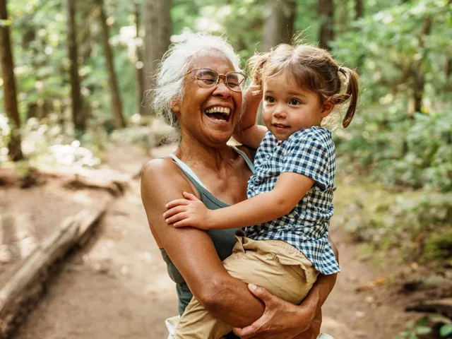 woman holding young girl in her hands modera raleigh hills apartment homes for rent in or
