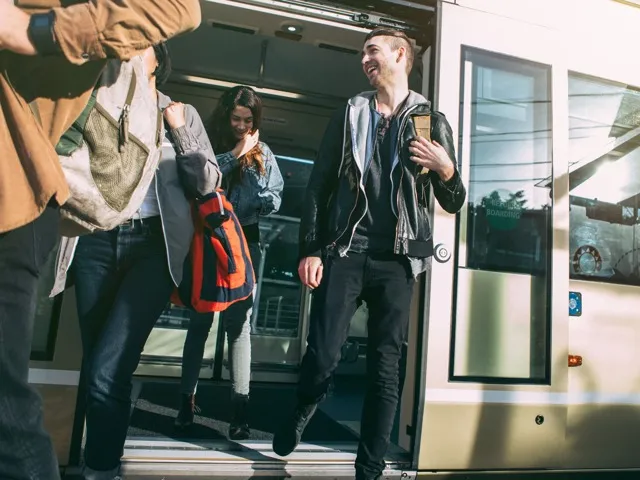 people getting off of metro train modera northgate apartment homes for rent