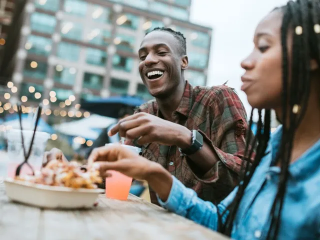 two people having dinner outside and smiling modera northgate apartment homes for rent in wa