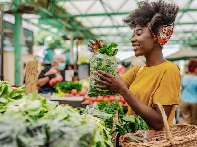 woman shopping at farmers market amavi kissimmee single family homes for rent in orlando fl