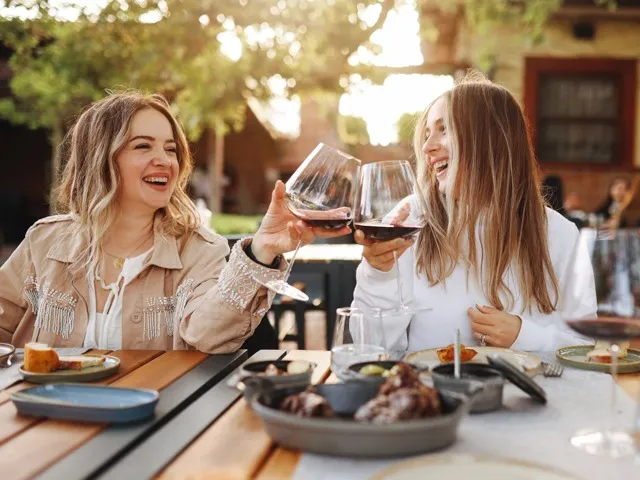 two women drinking wine at table beckett west fork apartment homes for rent in conroe tx
