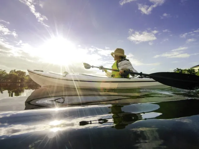 person kayaking on sunny day modera newton apartment homes for rent in ma