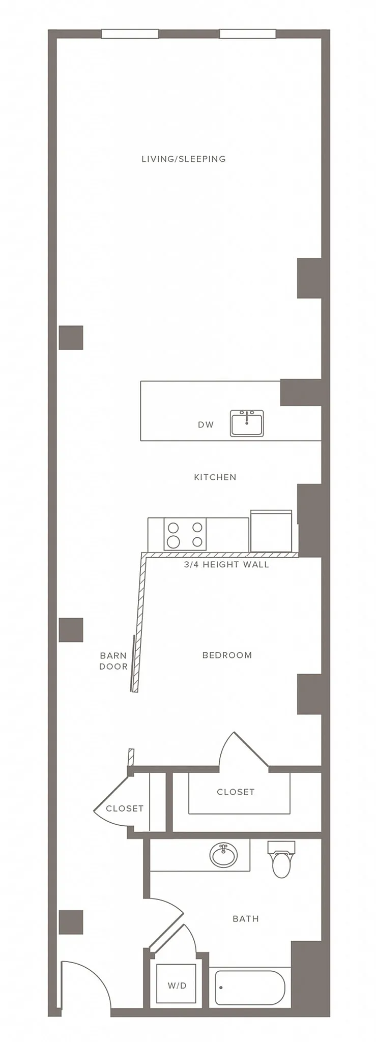 Sleek floor plan with spacious living/sleeping area, modern kitchen, and cozy bedroom featuring a barn door entry.