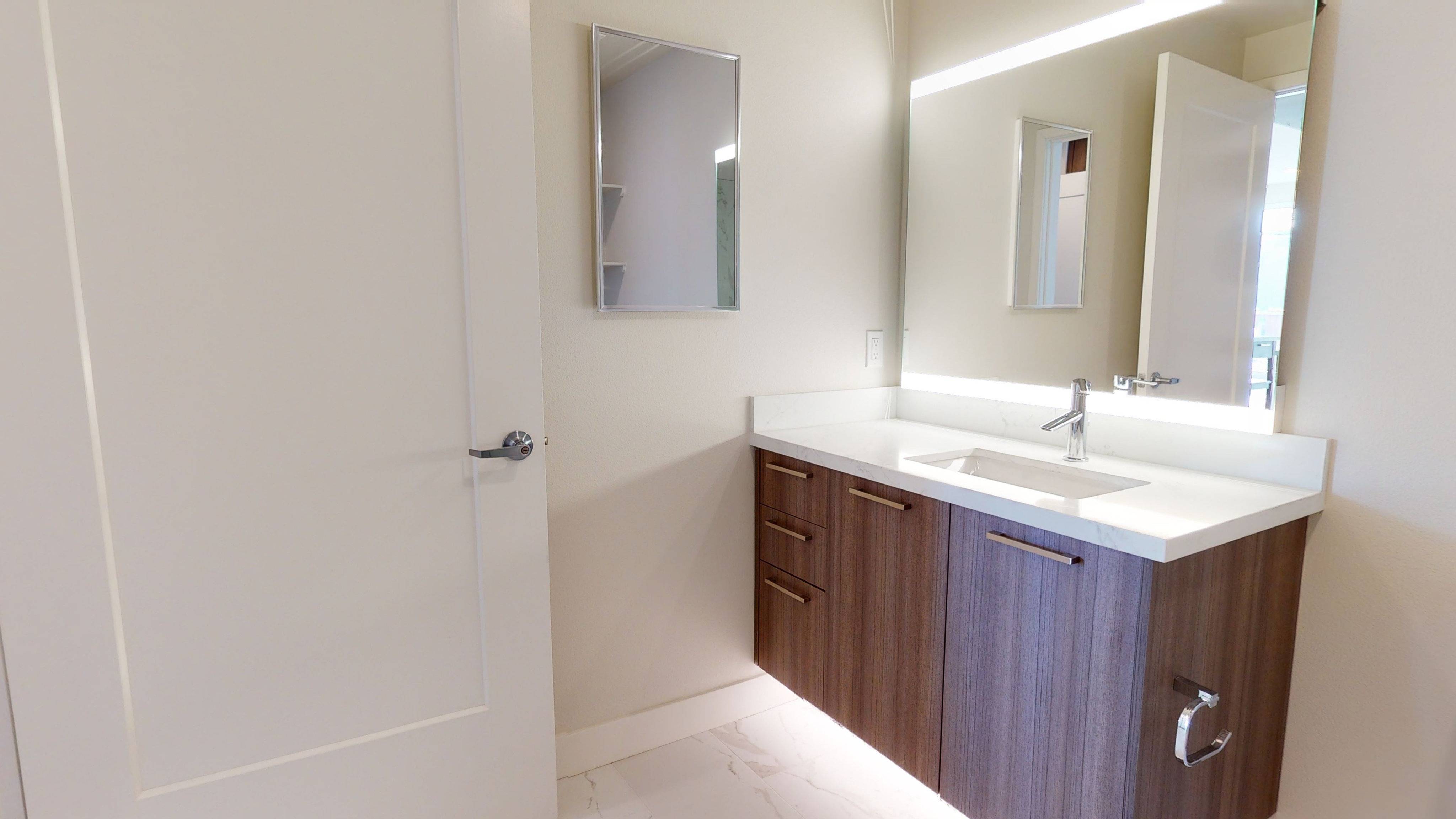 Floating vanity with under lighting and LED backlit vanities*