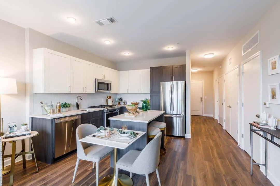 Two-toned kitchen cabinets with wood plank-style flooring