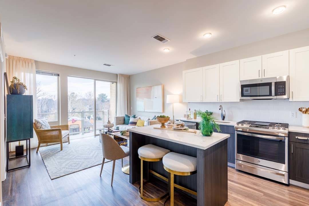 Kitchen at VERSO Founders Row with light cabinets and stainless steel appliances