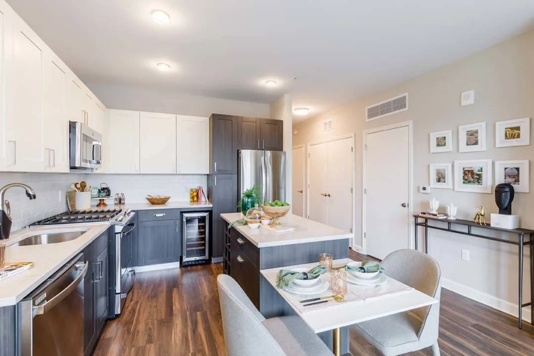 Two-toned cabinets and stainless steel appliances and wine cooler