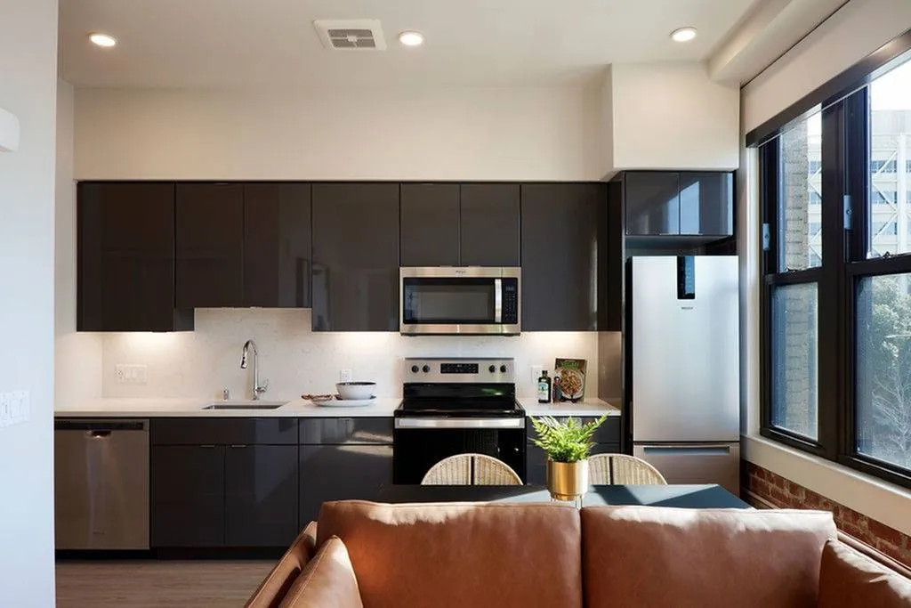 kitchen with dark cabinets and white quartz counters and backsplash