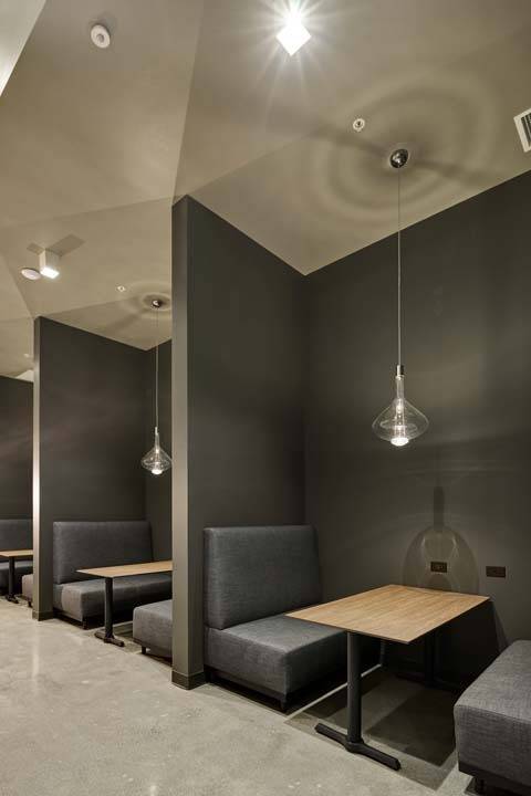 Coworking banquette seating and tabes with separators in lobby