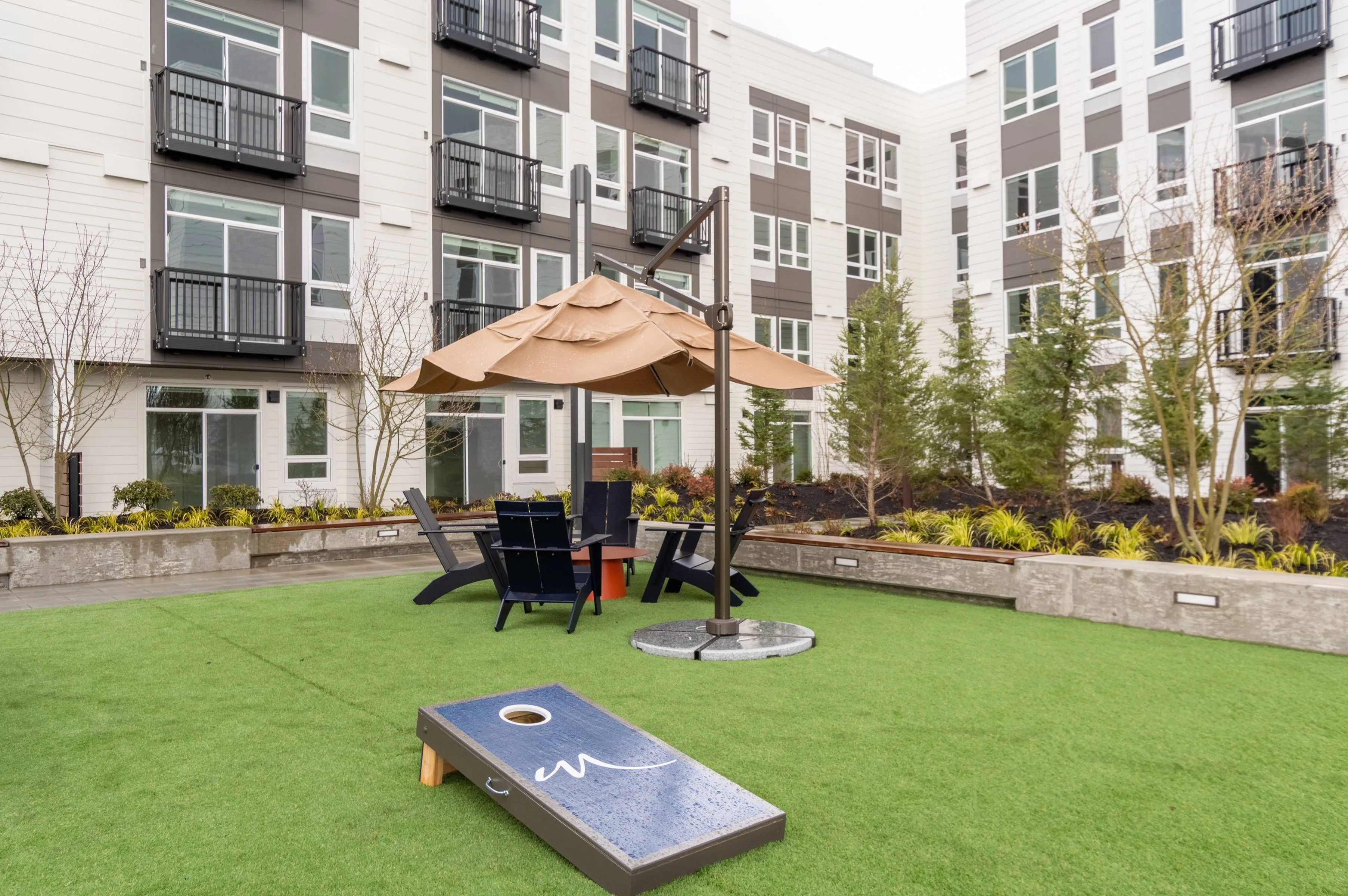 Courtyard featuring outdoor seating, cornhole games and landscaping