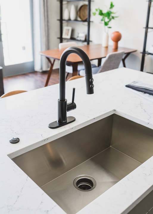 Sparkling quartz countertops and large basin sink