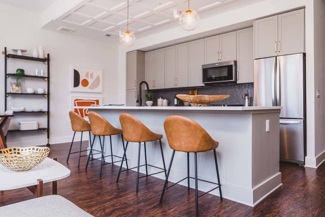 Double door refrigerator behind large island with seating