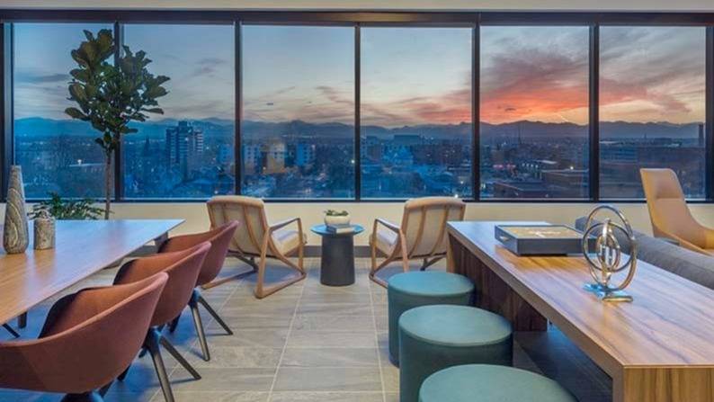 Sky lounge with stellar view at dusk with seating and work tables
