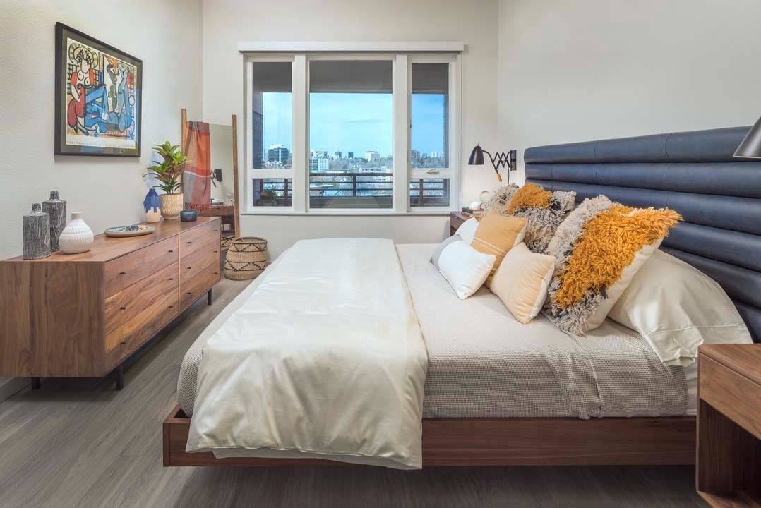 Bedroom showing a large window and ceiling fan