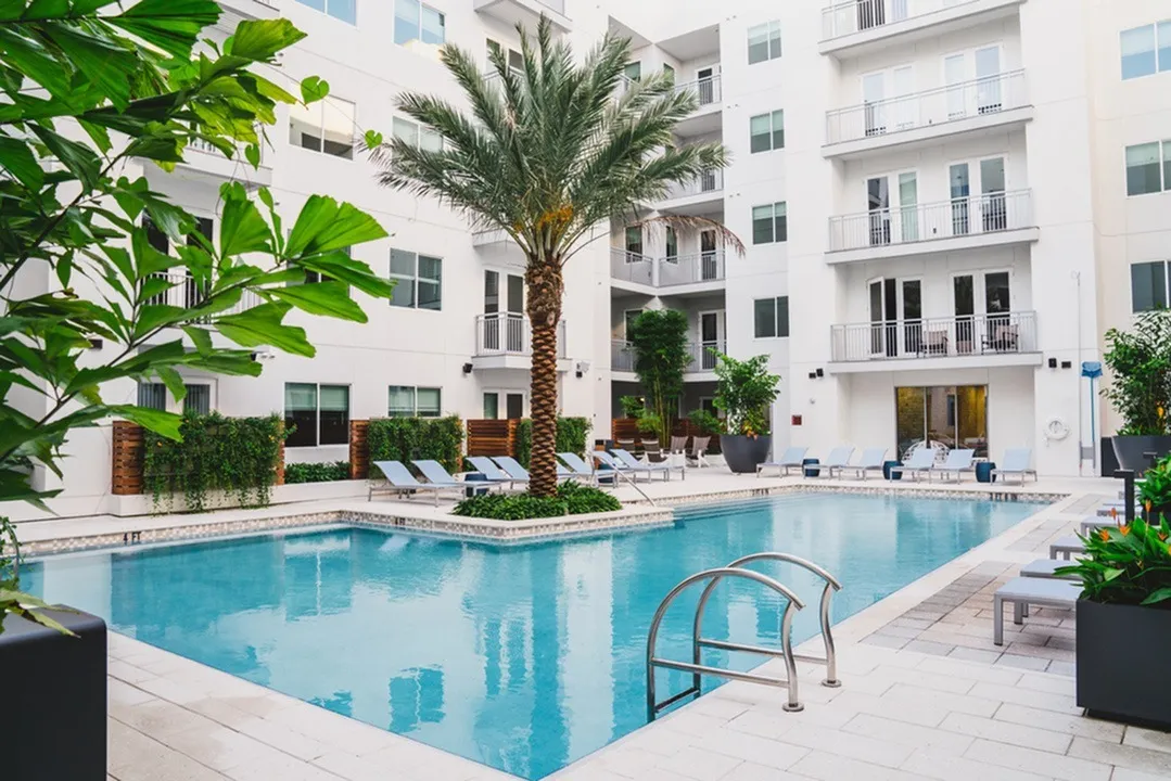 Image of woman sunbathing next to pool