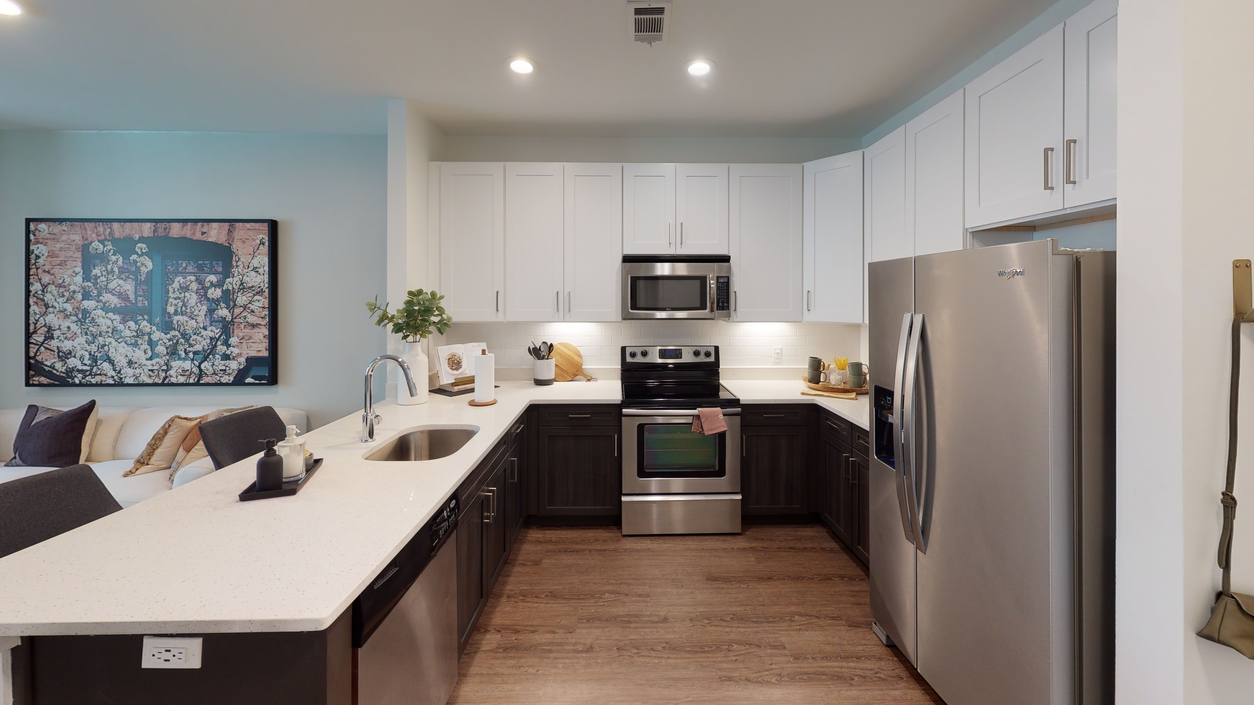 Upgraded kitchen with white and brown cabinets and stainless steel appliances