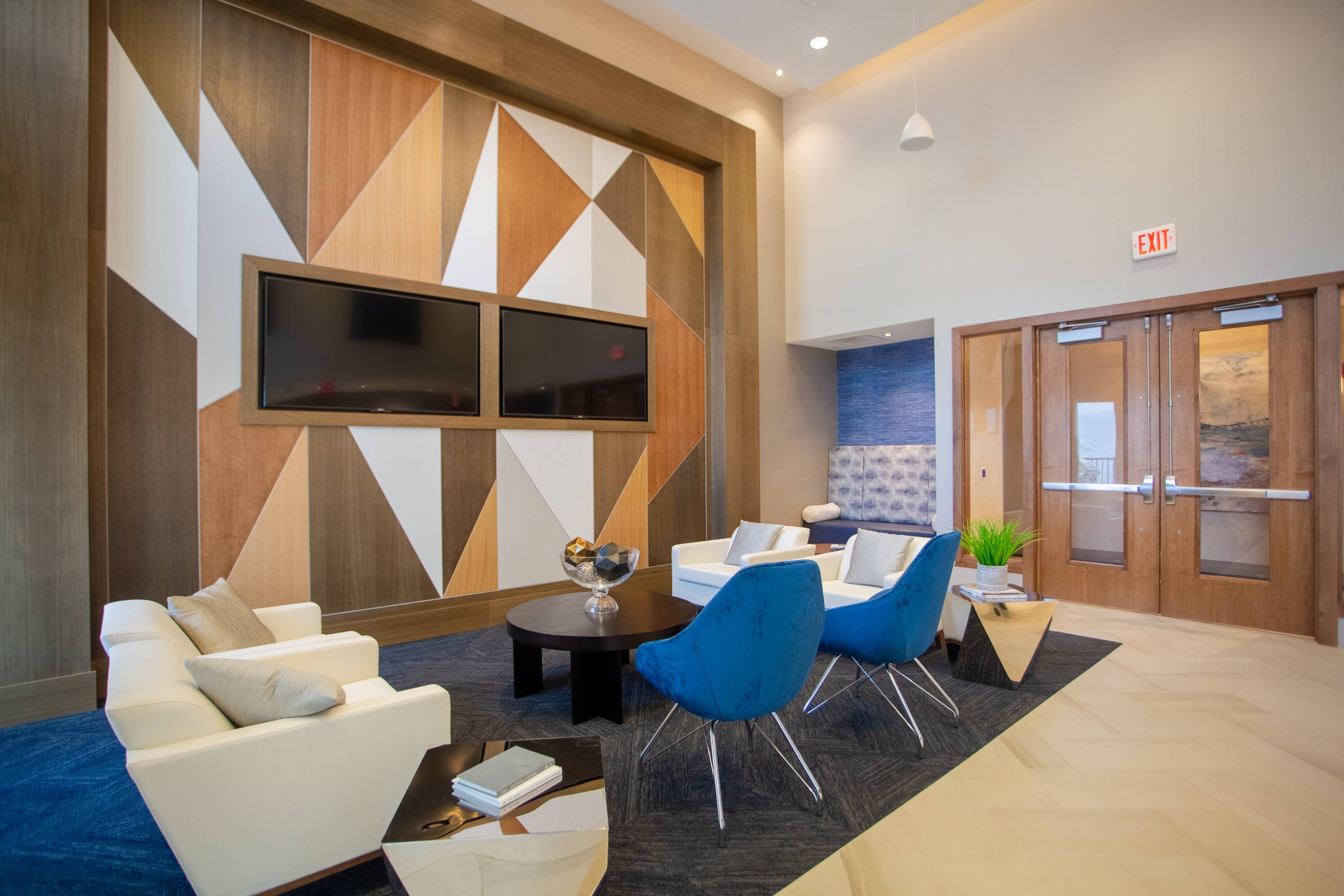 Modera 55 lounge space with white and blue accent chairs