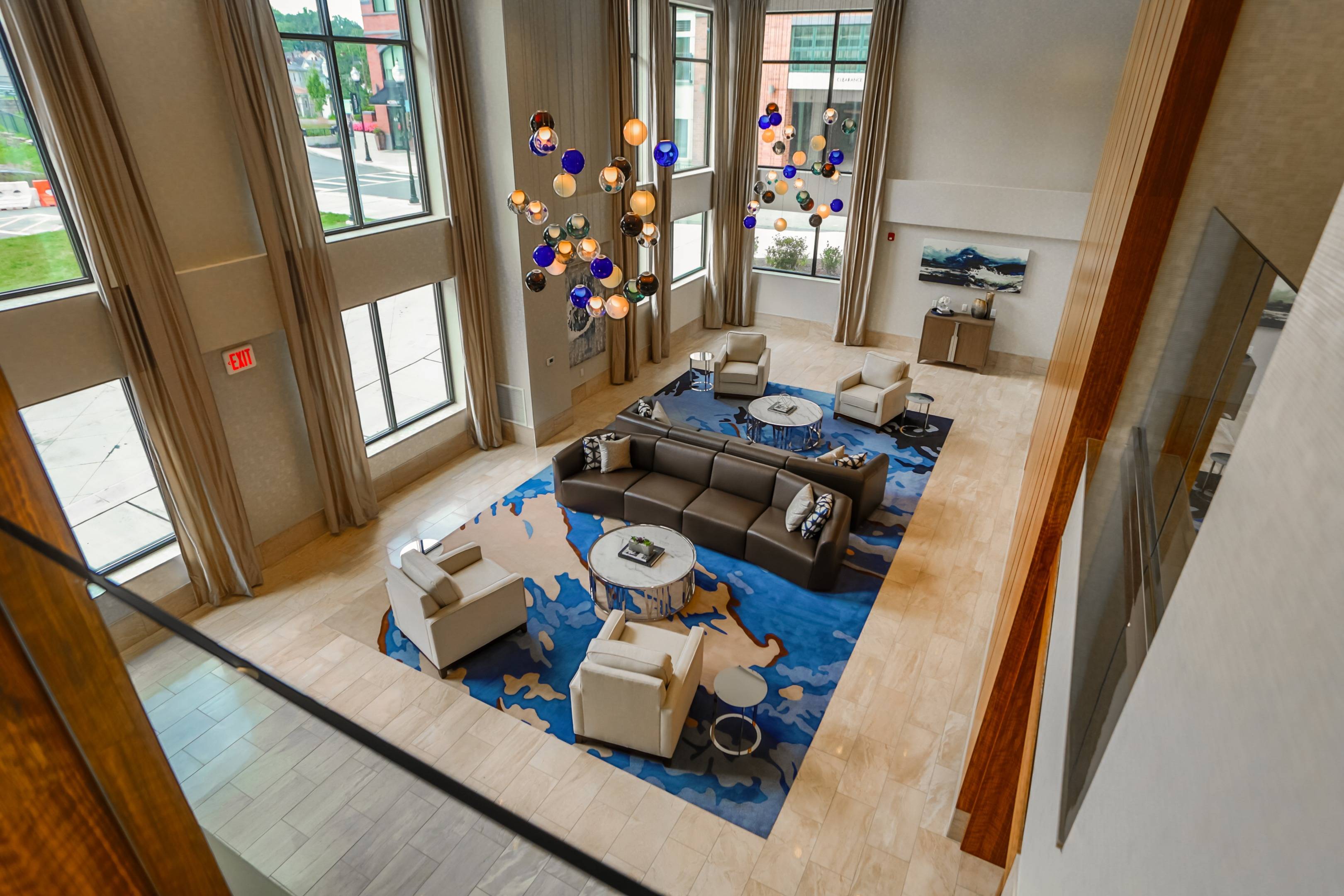 Modera 55 lounge space with white and blue accent chairs
