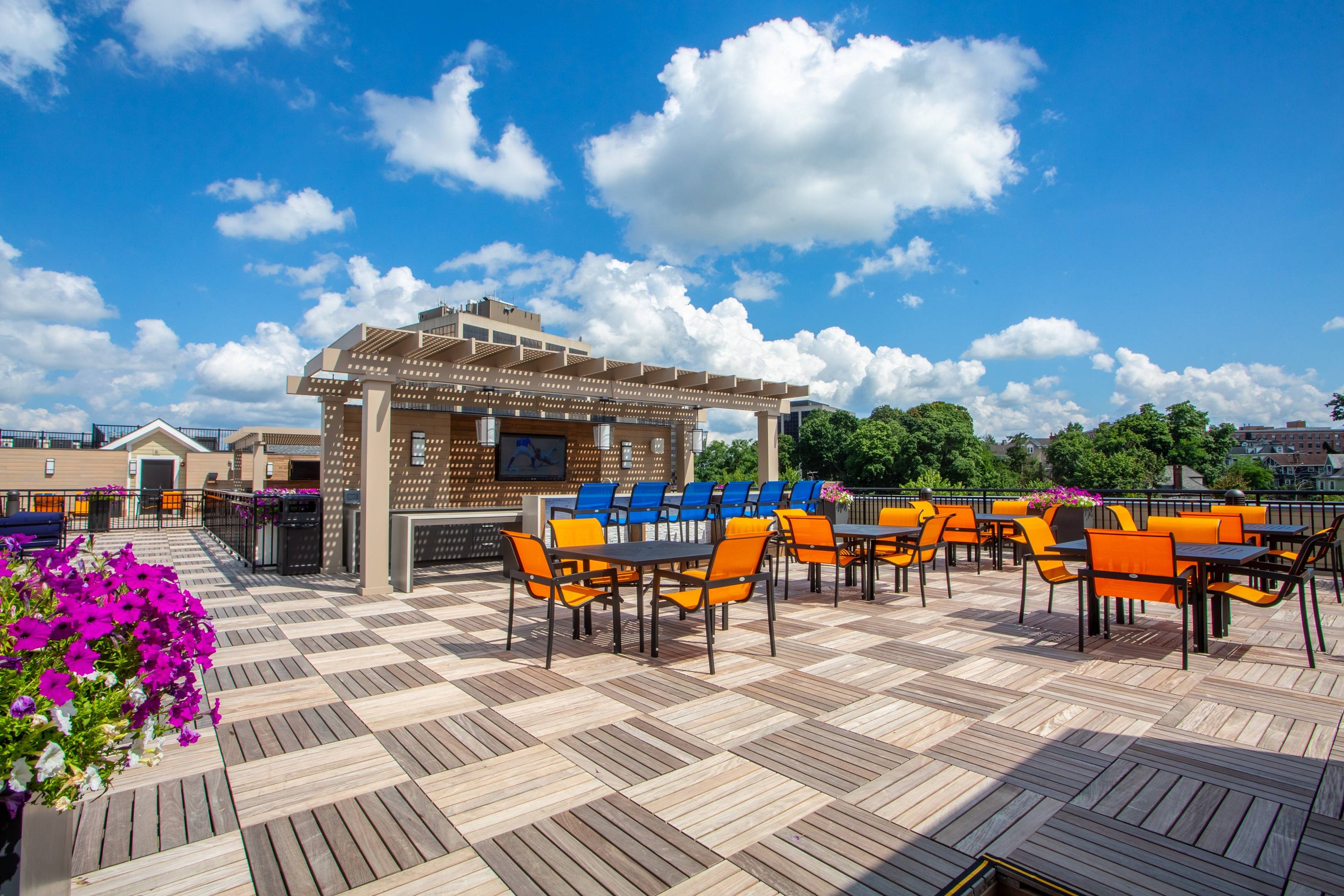 Modera 55 rooftop space with white and blue accent chairs