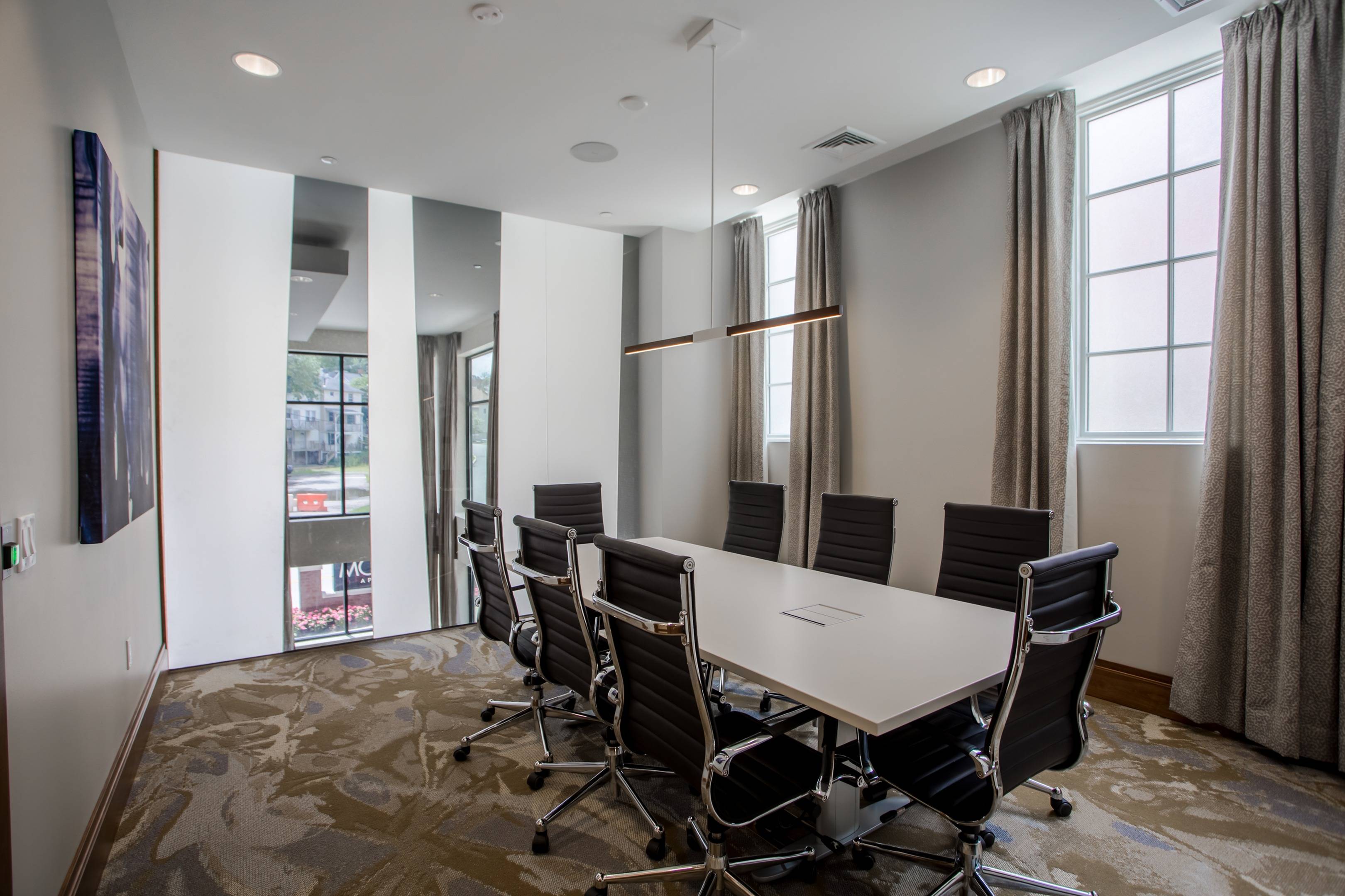 Modera 55 private conference room with table and chairs
