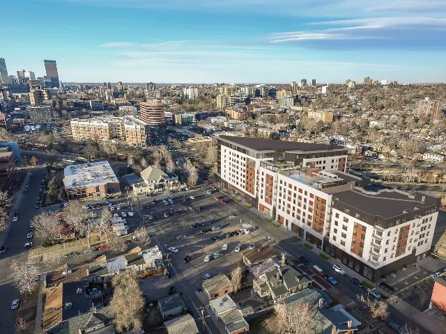 Exterior drone view rendering with slight view of downtown Denver
